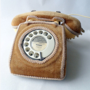rotary telephone with brown corduroy casing