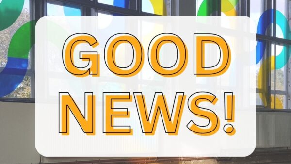 Background photo of the inside of a building with bright blue, green and yellow stained patterns on large windows across the wall. Orange text saying "Good News!" in white text box.